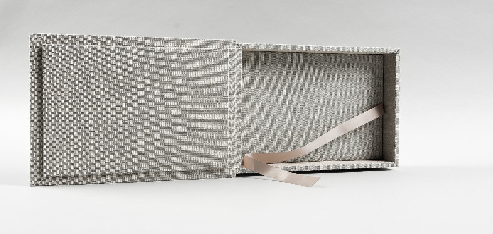 Handcrafted and finished both inside and outside in an elegant, gray canvas in the shade of Ashen.